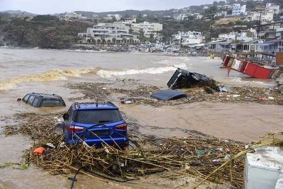 Cars submerged in water, following heavy thunderstorms, in the village of Agia Pelagia, on the island of Crete, Greece, Saturday, Oct. 15, 2022. It has been reported that at least one person has died  ...