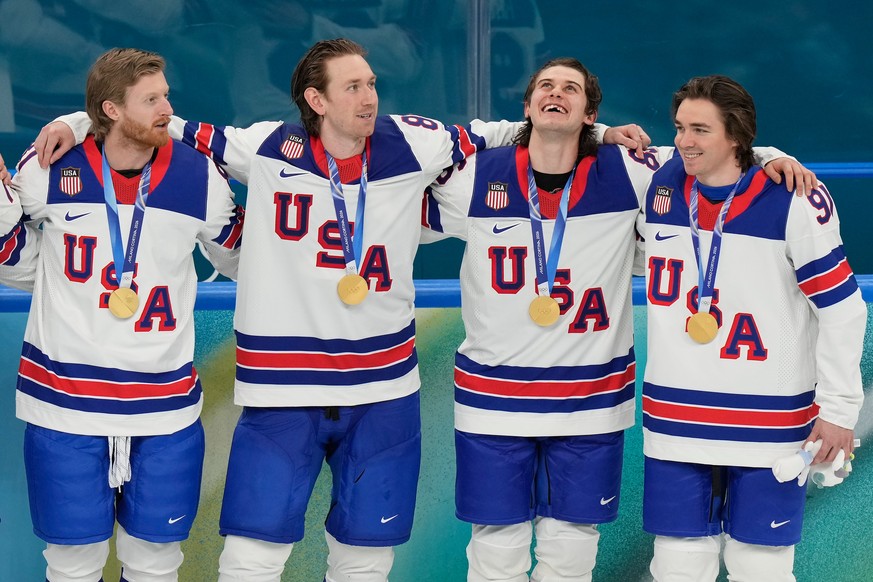 United States' Kyle Connor (81), Zach Werenski (8), Jack Hughes (86) and Clayton Keller (91) react after receiving their gold medals after the United States defeated Canada in the men's ice  ...