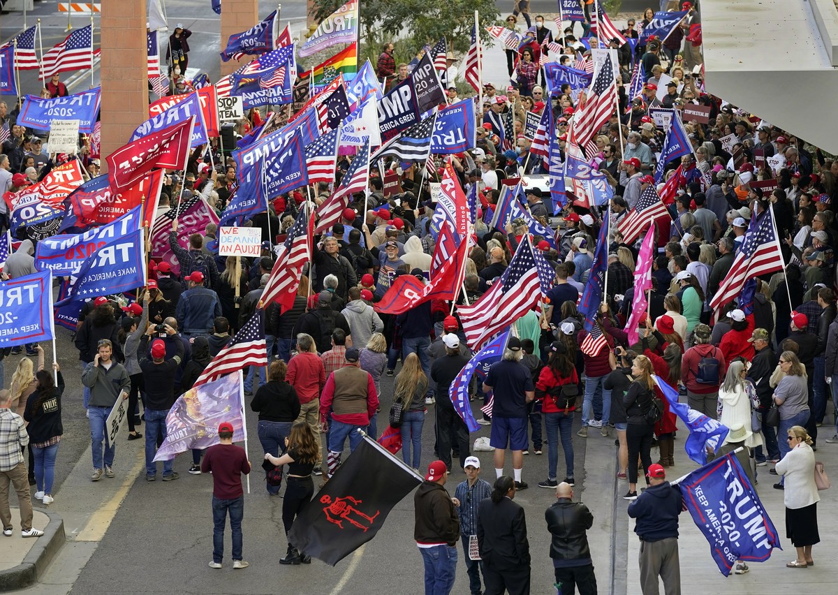 Supporters of President Donald Trump protest in front of a local hotel where Arizona Republicans have scheduled a meeting as a "fact-finding hearing" to discuss the election, featuring membe ...