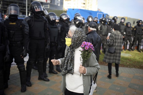 Police block the road to against an opposition rally protesting the official presidential election results in Minsk, Belarus, Sunday, Oct. 4, 2020. Hundreds of thousands of Belarusians have been prote ...