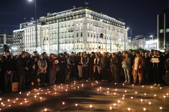 epa10501436 People lght candles in honor of the 57 victims of Greece&#039;s deadliest train crash, during a protest in front of Parliament in Athens, Greece, 03 March 2023. The death toll of the train ...