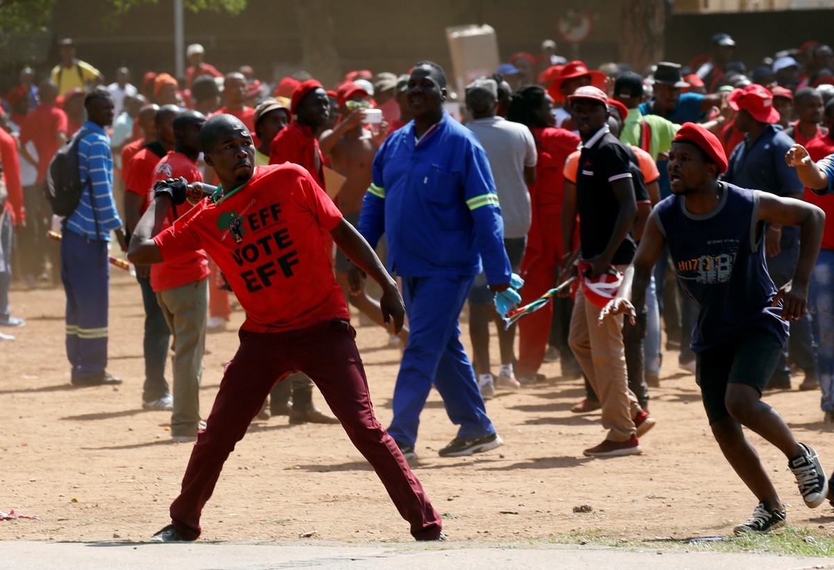 A protester throws a bottle at police during demonstrations calling for the removal of President Jacob Zuma outside the Union Buildings in Pretoria, South Africa, November 2, 2016. REUTERS/Mike Hutchi ...