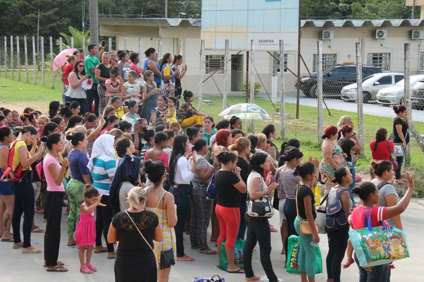 epa05695530 A handout photo made available by A. Critica shows relatives of inmates waiting for news after rioting at Anisio Jobim prison complex in Manaus, Amazonas state, Brazil, 02 January 2017. At ...