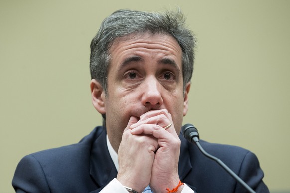 epaselect epa07402694 Michael Cohen, former attorney to US President Donald J. Trump, reacts while listening to the closing remarks of House Oversight and Reform Committee Chairman Elijah Cummings, wh ...