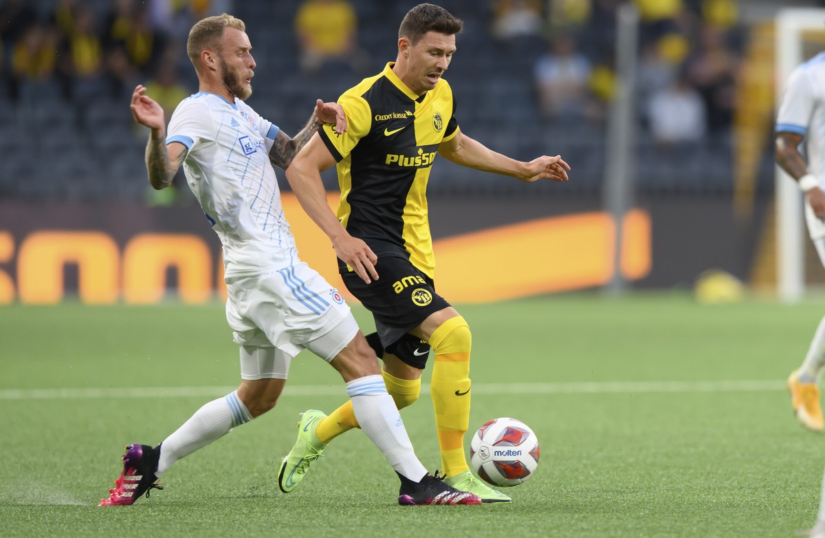 Slovan Bratislava's Joeri de Kamps, left, and Young Boys' Christian Fassnacht, center, fight for the ball during the Champions League second qualifying round, second leg soccer match between ...