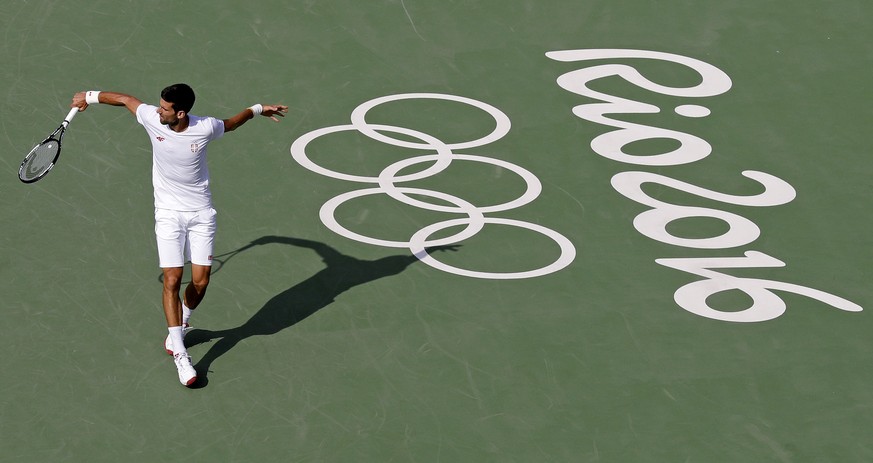 Novak Djokovic, of Serbia, returns as he practices on center court prior to the 2016 Summer Olympics in Rio de Janeiro, Brazil, Thursday, Aug. 4, 2016. (AP Photo/Charles Krupa)