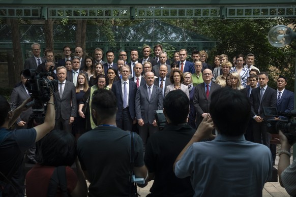 Jim Nickel, front row center, the deputy chief of mission for the Canadian Embassy in China, and diplomatic representatives from more than two dozen other countries pose for a group photo at an event  ...