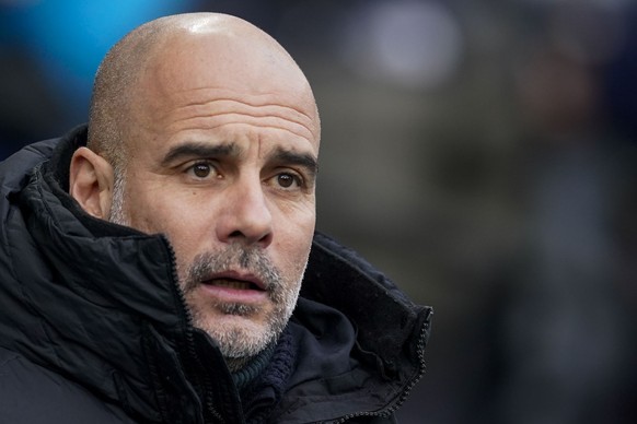 Manchester City&#039;s head coach Pep Guardiola looks on prior the English FA Cup third round soccer match between Manchester City and Huddersfield Town, at the Etihad stadium in Manchester, England,  ...