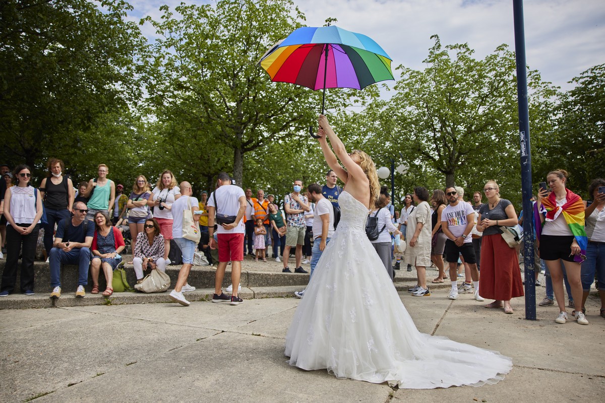 Une femme en robe de mariee defile avec un parapluie aux couleurs de l'arc en ciel lors d'un evenement pour le lancement de la campagne en faveur du mariage pour toutes et tous, le dimanche  ...