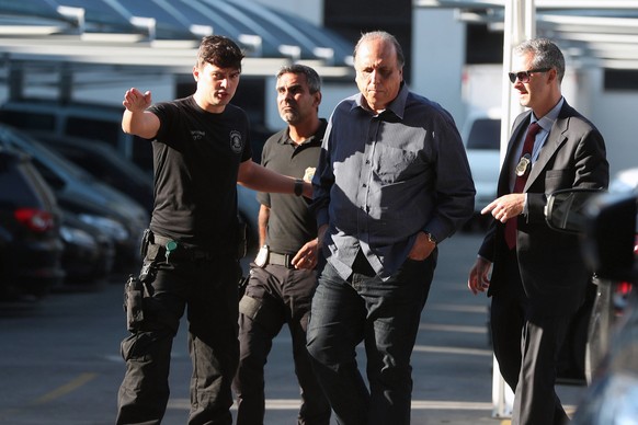 epa07196970 Police officers escort Rio de Janeiro Governor, Luiz Fernando Pezao (2-R), following his arrest in Rio Janeiro, Brazil, 29 November 2018. Pezao has been arrested within the so-called &#039 ...