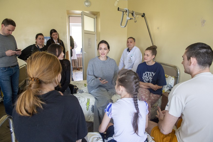 epa09921480 US Actress and UN Goodwill Ambassador Angelina Jolie talks to people as she visits victims of the Kramatorsk railway station missile strike in Lviv children&#039;s hospital, in Western Ukr ...