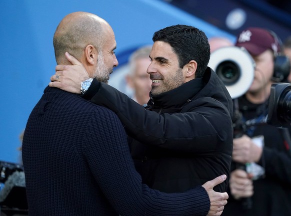 Manchester City v Arsenal - Premier League - Etihad Stadium Manchester City manager Pep Guardiola left and Arsenal manager Mikel Arteta embrace before the Premier League match at the Etihad Stadium, M ...