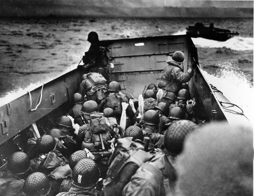 FILE - In this photo provided by the U.S. Coast Guard, a U.S. Coast Guard landing barge, tightly packed with helmeted soldiers, approaches the shore at Normandy, France, during initial Allied landing  ...