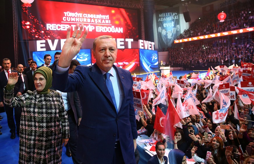 Turkish President Tayyip Erdogan, accompanied by his wife Emine Erdogan, greets his supporters during a campaign meeting for the April 16 constitutional referendum, in Ankara, Turkey, March 7, 2017. K ...