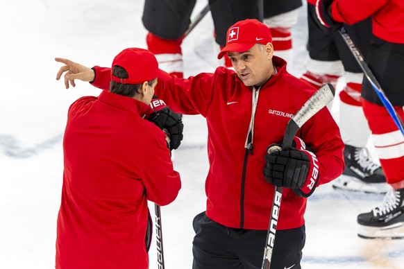 Jan Cadieux Jan, right, assistant coach of Switzerland national ice hockey team, speaks with Patrick Fischer, left, head coach of Switzerland national ice hockey team, during a training session of tea ...