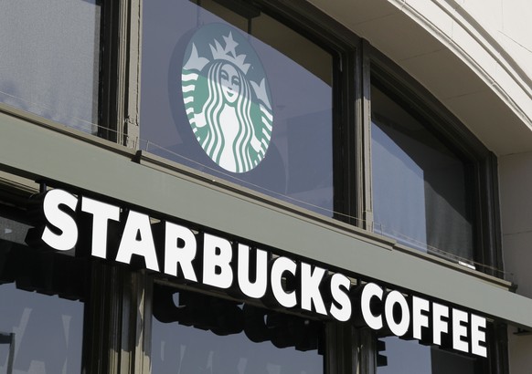 File - This April 6, 2012 file photo shows a Starbucks store on the Embarcadero in San Francisco. Starbucks and other employers in California must pay workers for minutes they routinely spend off the  ...