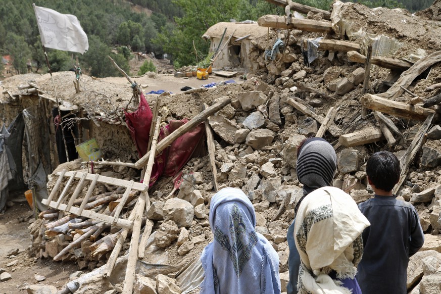 Afghan children stand near a house that was destroyed in an earthquake in the Spera District of the southwestern part of Khost Province, Afghanistan, Wednesday, June 22, 2022. A powerful earthquake st ...