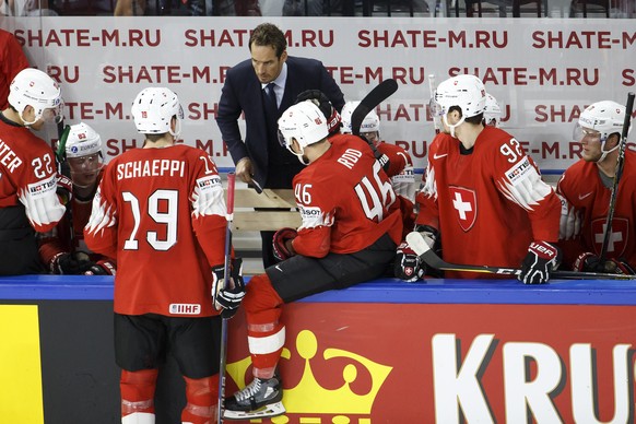 Patrick Fischer, head coach of Switzerland national ice hockey team, speaks to his player forward Reto Schaeppi #19 past forward Nino Niederreiter #22, forward Noah Rod #46, forward Gaetan Haas #92 an ...