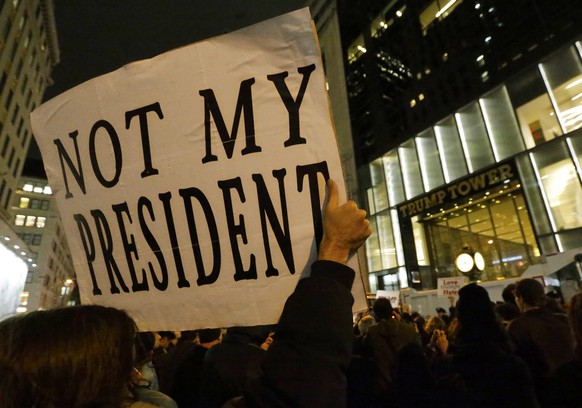 epa05624847 People protest against the election of Donald Trump as President of the United States, out front of Trump Tower in New York, New York, USA, 09 November 2016. President-elect Donald Trump w ...