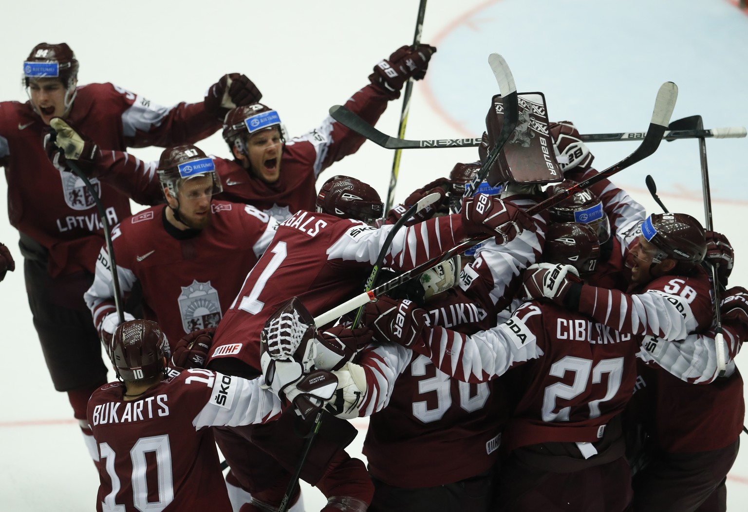 Players of Latvia celebrate after the Ice Hockey World Championships group B match between Denmark and Latvia at the Jyske Bank Boxen arena in Herning, Denmark, Tuesday, May 15, 2018. (AP Photo/Petr D ...