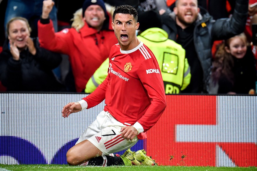 epa09535078 Manchester United's Cristiano Ronaldo celebrates after scoring the 3-2 lead during the UEFA Champions League group F soccer match between Manchester United and Atalanta BC in Manchester, B ...