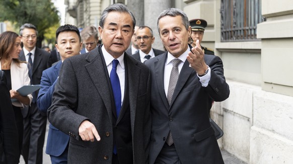 Swiss Foreign minister, Federal Councillor Ignazio Cassis, right, walks to a joint press conference with his guest Wang Yi, Foreign Minister of the PeopleÕs Republic of China, staying on an official w ...