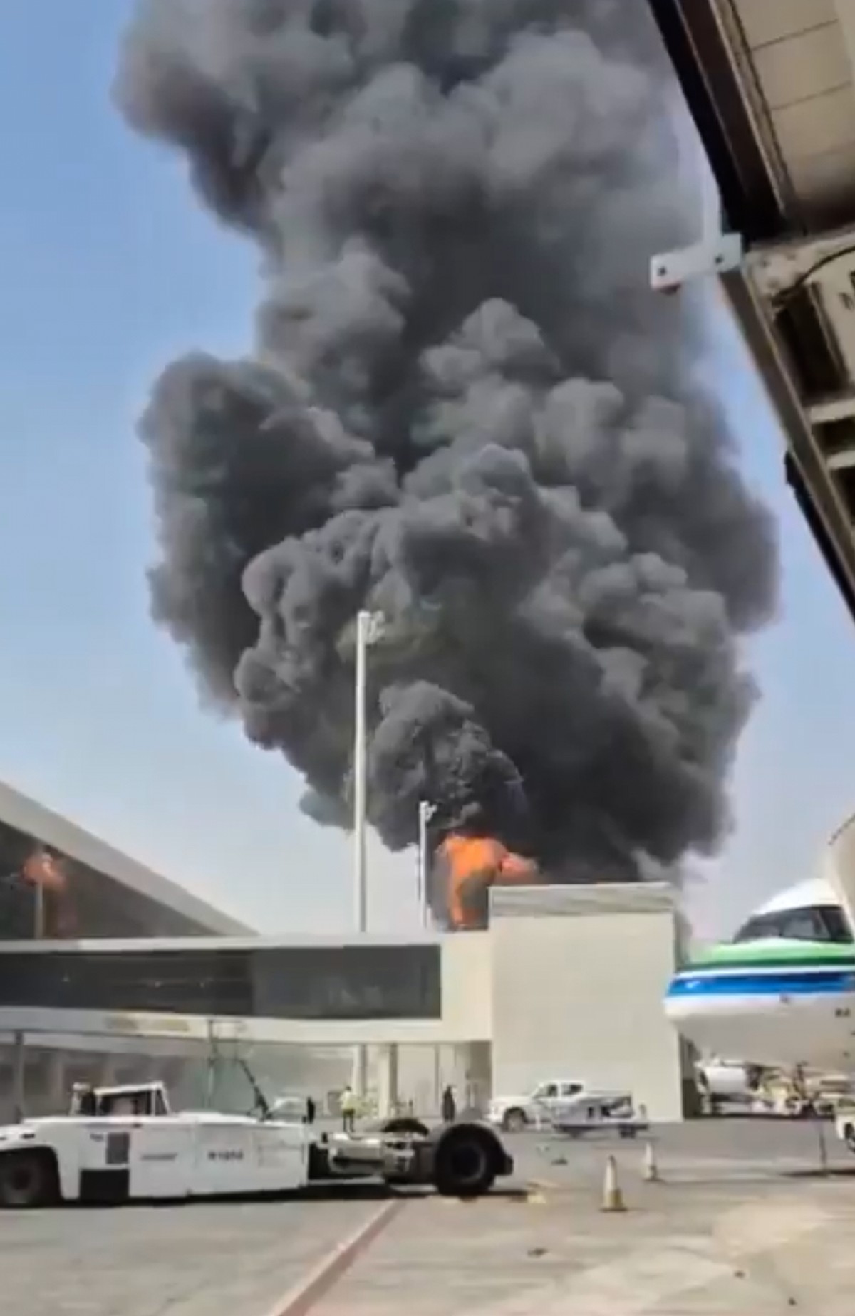 This image from video obtained and verified by AP shows thick black smoke and flames rising from a fire at King Khalid International Airport in Riyadh, Saudi Arabia, Thursday, Oct. 8, 2026. (UGC via A ...