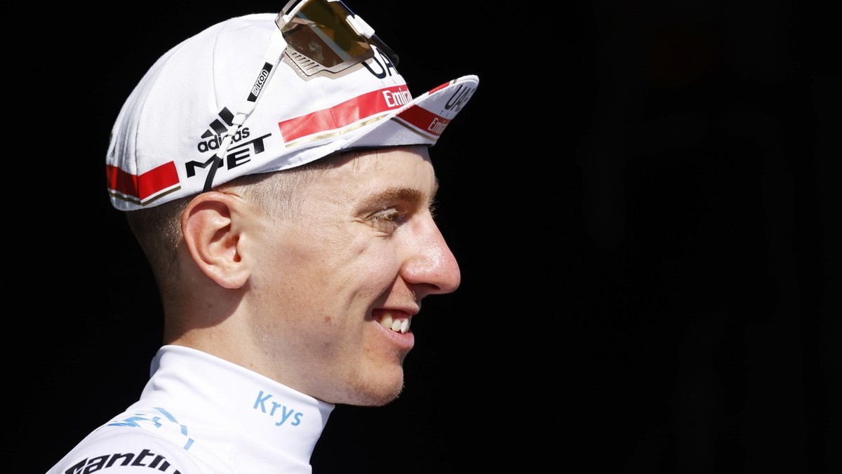 epa10074594 Slovenian rider Tadej Pogacar of UAE Team Emirates celebrates on the podium retaining the best young rider's white jersey following the 14th stage of the Tour de France 2022 over 192. ...