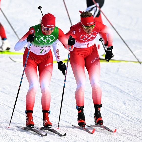 epa09748627 Nadine Faehndrich of Switzerland (L) takes over from Laurien van der Graaff of Switzerland (R) during the Women&#039;s 4x5km Relay race at the Zhangjiakou National Cross-Country Skiing Cen ...