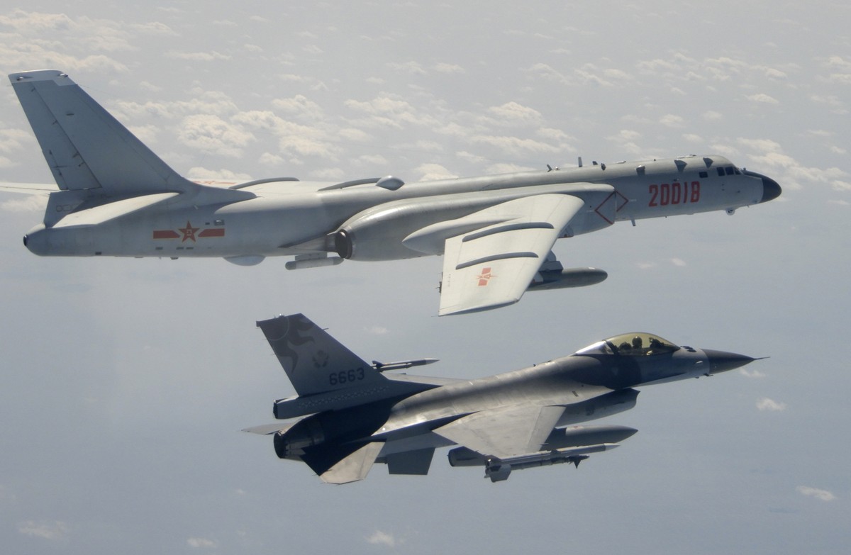 FILE - In this Feb. 10, 2020, file photo and released by the Republic of China (ROC) Ministry of National Defense, a Taiwanese Air Force F-16 in foreground flies on the flank of a Chinese People' ...