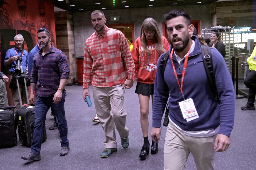 FILE - Kansas City Chiefs tight end Travis Kelce, center left, and singer Taylor Swift leave Arrowhead Stadium after an NFL football game between the Chiefs and the Los Angeles Chargers, Oct. 22, 2023 ...