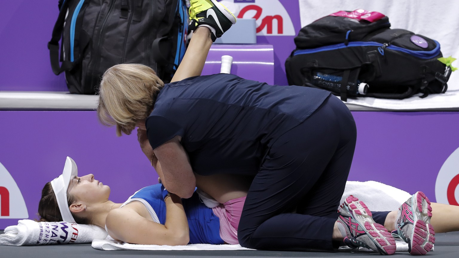 Belinda Bencic of Switzerland receives medical attention during the WTA Finals Tennis Tournament against Elina Svitolina of Ukraine at the Shenzhen Bay Sports Center in Shenzhen, China&#039;s Guangdon ...