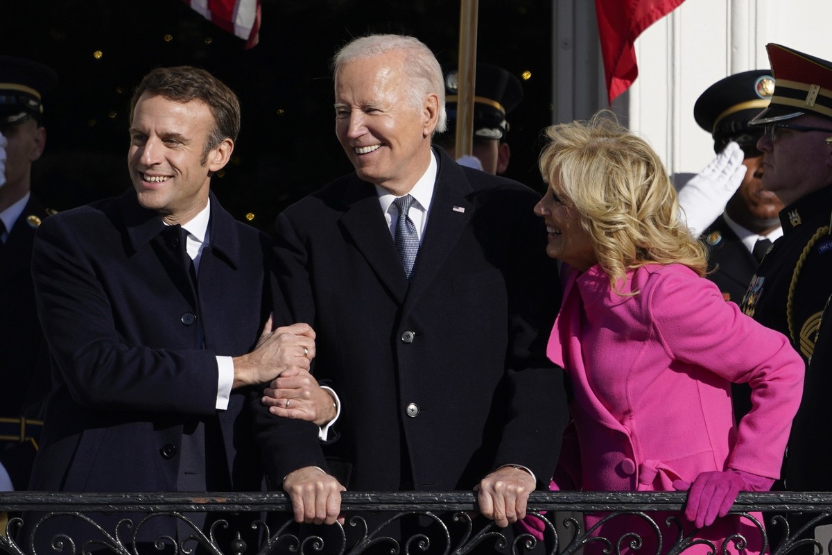 French President Emmanuel Macron embraces President Joe Biden alongside first lady Jill Biden during a State Arrival Ceremony on the South Lawn of the White House in Washington, Thursday, Dec. 1, 2022 ...