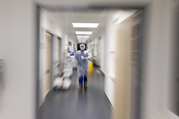 A nurse walks across a corridor in the intensive care unit at the University Medical Center Schleswig-Holstein in Kiel, Germany, Thursday, Dec. 3, 2020. The number of corona patients in German intensi ...
