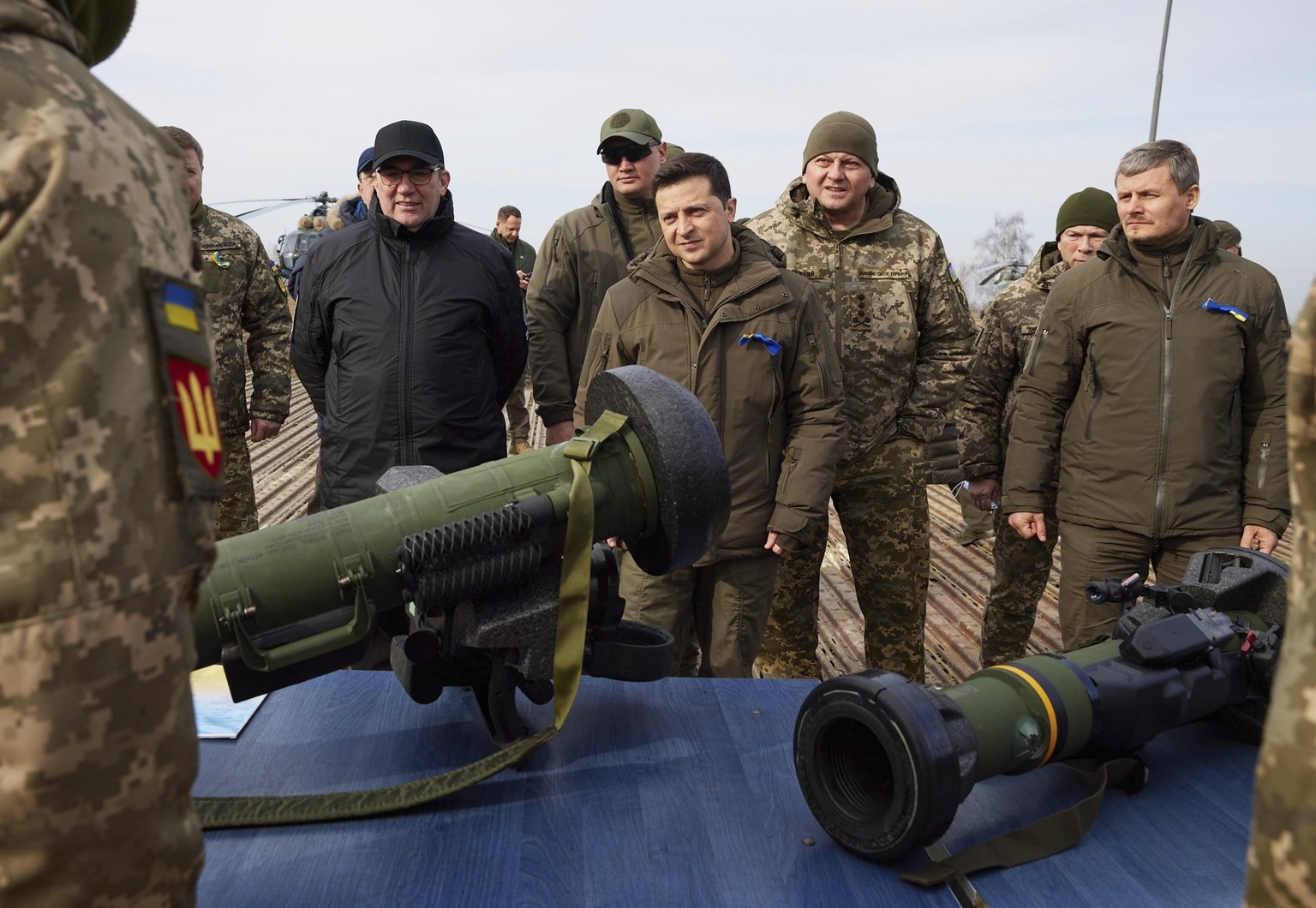 Ukrainian President Volodymyr Zelenskyy, center left, is shown NLAW anti-tank weapons during a military drill outside the city of Rivne, northern Ukraine, Wednesday, Feb. 16, 2022. (Ukrainian Presiden ...