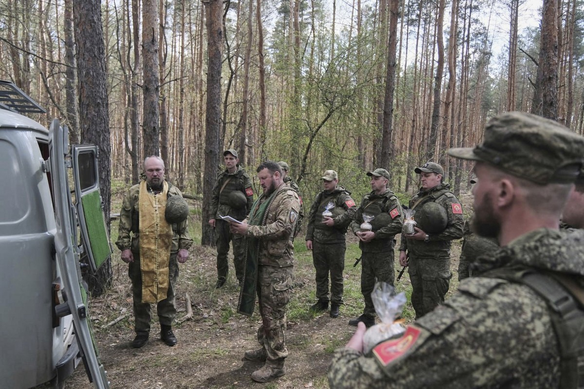 In this photo taken from video distributed by Russian Defense Ministry Press Service on Sunday, April 20, 2025, Russian soldiers attend a religion service on eve of Orthodox Easter at an unspecified l ...