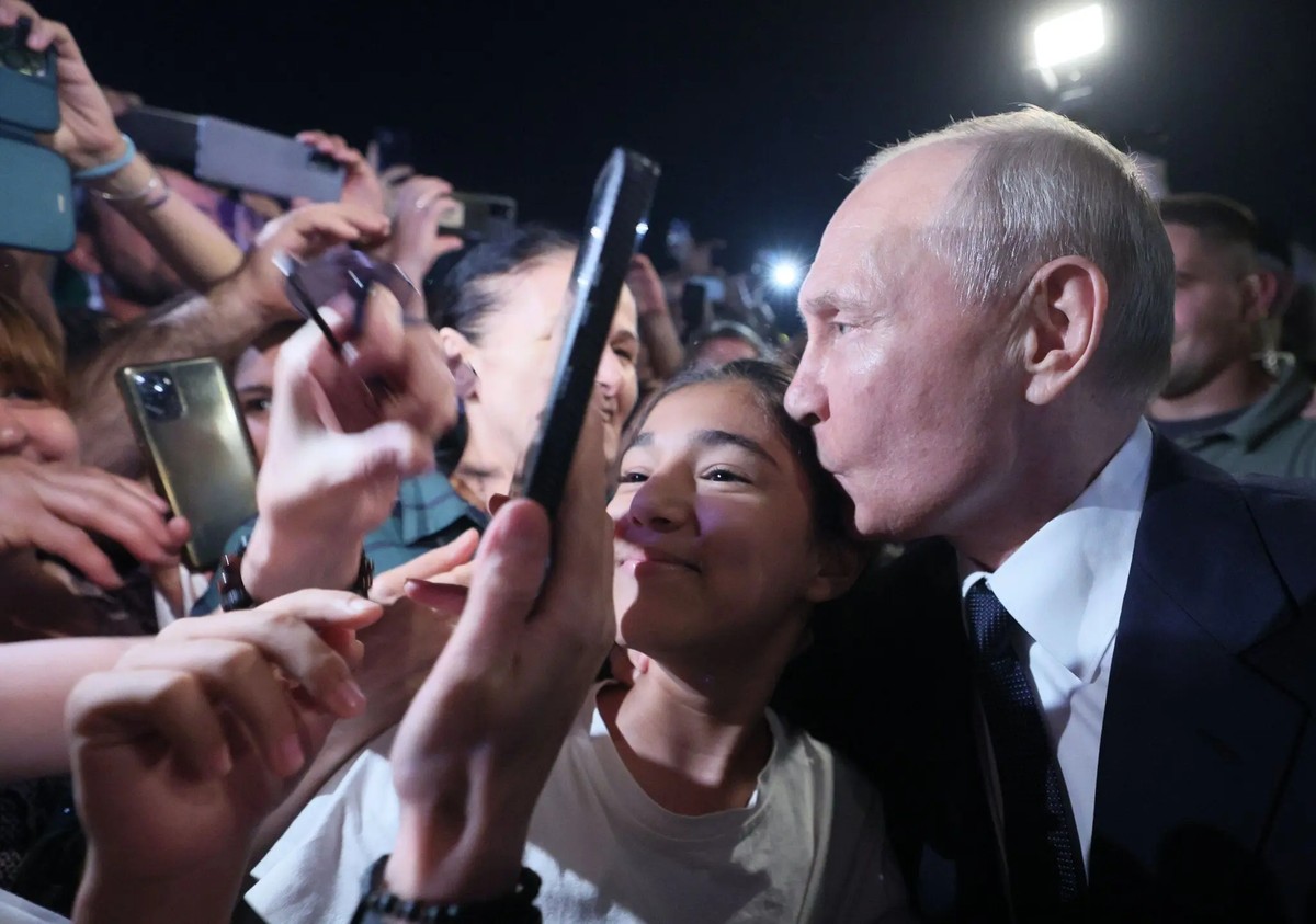 Le président russe Vladimir Poutine, à droite, pose pour un selfie avec des citoyens locaux lors de sa visite de travail dans la République du Daghestan, à Derbent, Russie, mercredi 28 juin 2023.