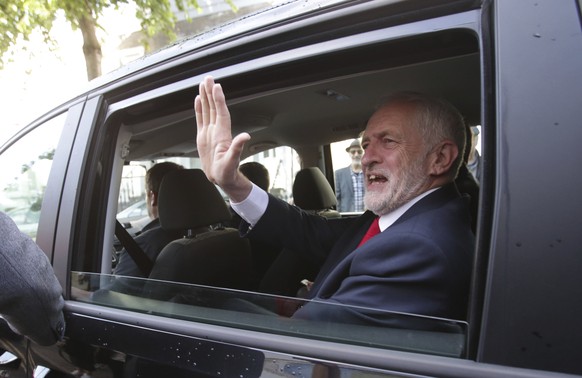 Labour leader Jeremy Corbyn waves as he leaves his home in north London, Friday June 9, 2017. British Prime Minister Theresa May's gamble in calling an early general election backfired spectacularly, as her Conservative Party lost its majority in Parliament and pressure mounted on her Friday to resign.  (Yui Mok/PA via AP)