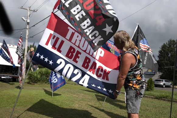 August 22, 2021, Cullman, Alabama, USA: Unofficial campaign flags and buttons for former President Donald Trump are consistent sellers at a roadside vendor tent in northern Alabama, where a massive po ...