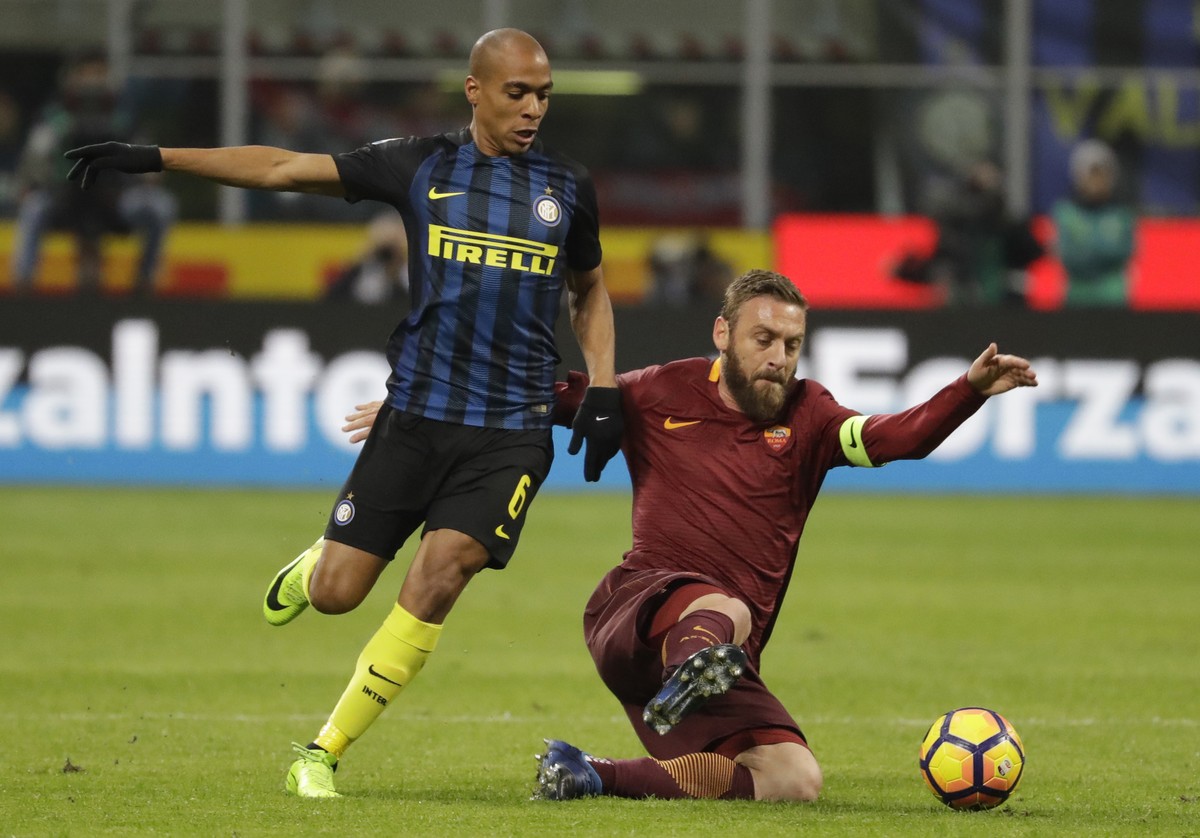 Roma's Daniele De Rossi, right, and Inter Milan's Joao Mario vie for the ball during an Italian Serie A soccer match between Inter Milan and Roma, at the San Siro stadium in Milan, Italy, Su ...