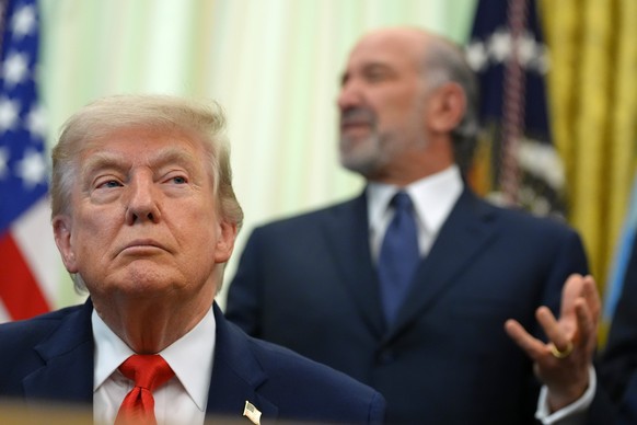 Commerce Secretary Howard Lutnick speaks before President Donald Trump, in foreground, signs a proclamation about the fishing industry, in the Oval Office of the White House, Thursday, June 11, 2026,  ...