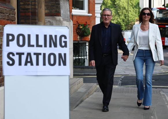 epa12937912 Britain's Prime Minister Keir Starmer (L) and his wife Victoria (R) arrive at a polling station in London, Britain, 07 May 2026. Local elections take place across the United Kingdom o ...