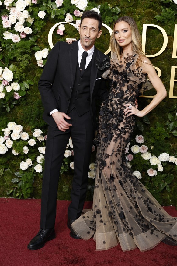epa11808616 Adrien Brody (L) and Georgina Chapman (R) arrive for the 82nd annual Golden Globe Awards ceremony at the Beverly Hilton Hotel in Beverly Hills, California, USA, 05 January 2025. Artists in ...