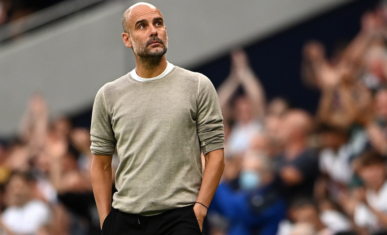 epa09415637 Man City manager Pep Guardiola during his teams 0-1 loss to Tottenham during an English Premier League soccer match at the Tottenham Hotspur Stadium in London, Britain, 15 August 2021. EPA ...