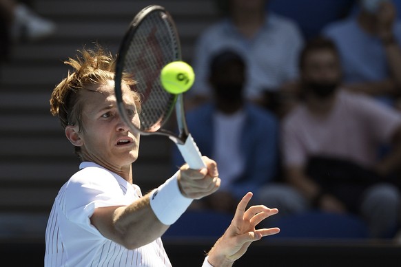 Sebastian Korda of the U.S. plays a forehand return to Cameron Norrie of Britain during their first round match at the Australian Open tennis championships in Melbourne, Australia, Monday, Jan. 17, 20 ...