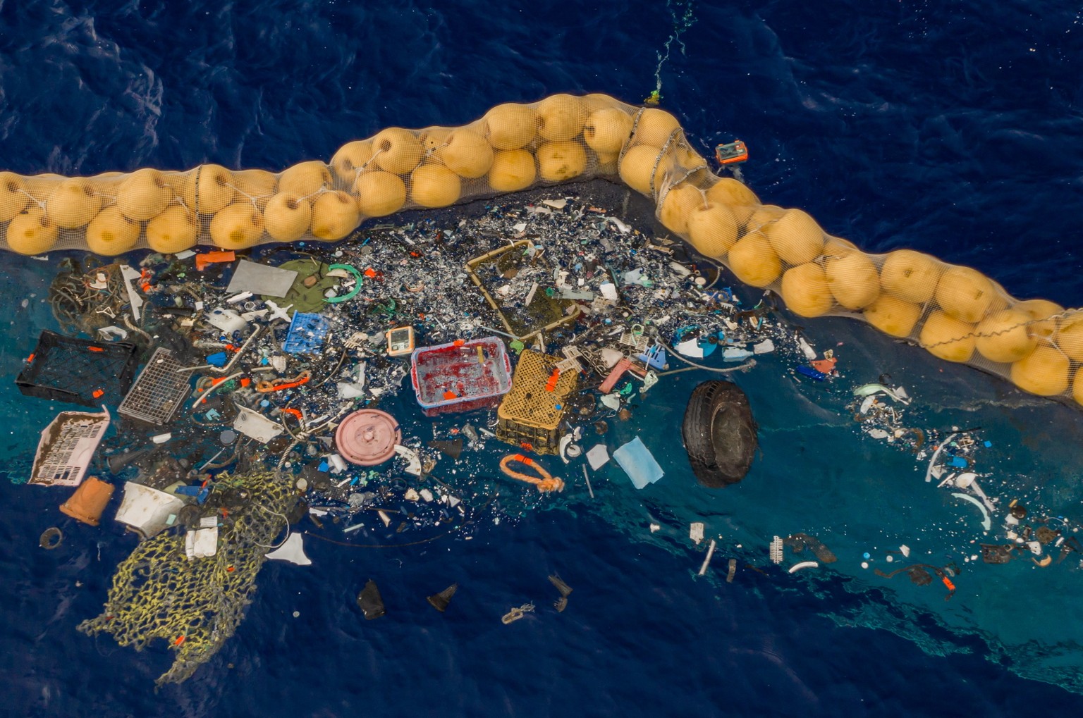 epa07892087 A handout photo made available by The Ocean Cleanup shows the company's ocean cleanup prototype System 001/B capturing plastic debris in the Great Pacific Garbage Patch, in the Pacific Oce ...