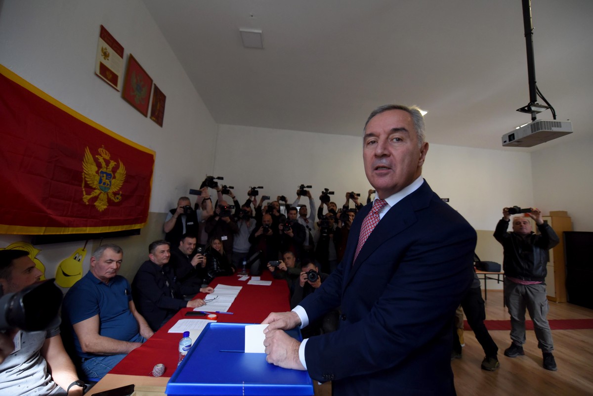 epa10531872 Presidential candidate and incumbent Montenegro's President Milo Djukanovic casts his ballot during the first round of the Presidential elections in Podgorica, Montenegro, 19 March 20 ...