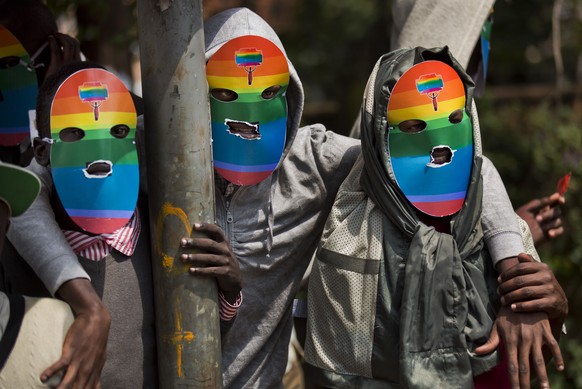 FILE - Kenyan gays and lesbians and others supporting their cause wear masks to preserve their anonymity as they stage a rare protest against Uganda's tough stance on homosexuality and in so…