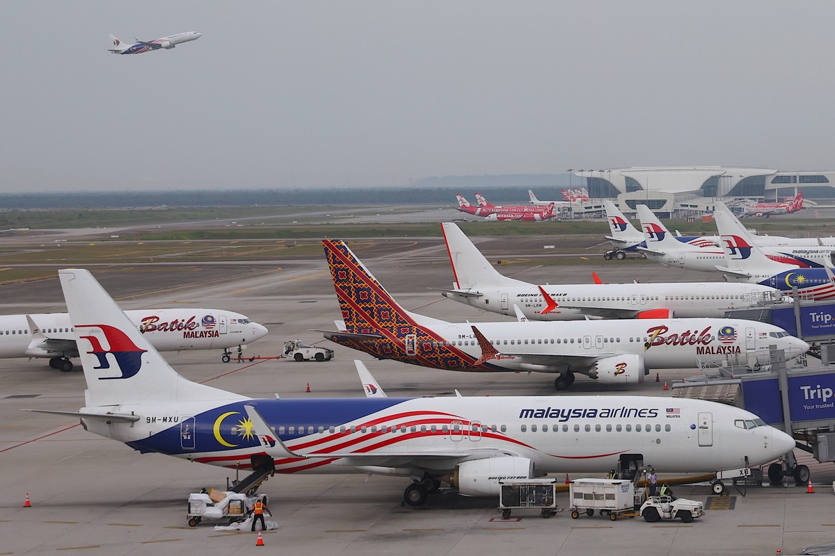 epa11948219 Malaysia Airlines planes are parked at the Kuala Lumpur International Airport, on the 11th anniversary of missing Malaysia airlines MH370 in Sepang, outside Kuala Lumpur, Malaysia, 08 Marc ...