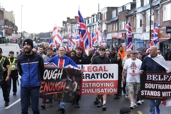 Demonstrators march along Portswood Road in Southampton, England, on Tuesday, June 9, 2026, during an Enough is Enough protest, after a man from Sudan was arrested over a knife attack in Belfast. (And ...